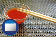 colorado map icon and chopsticks and red hot sauce in a Chinese restaurant