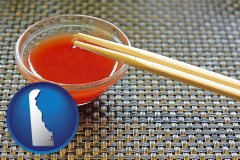 delaware map icon and chopsticks and red hot sauce in a Chinese restaurant