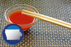 iowa map icon and chopsticks and red hot sauce in a Chinese restaurant