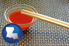 louisiana map icon and chopsticks and red hot sauce in a Chinese restaurant