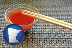 minnesota map icon and chopsticks and red hot sauce in a Chinese restaurant