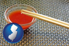 new-jersey map icon and chopsticks and red hot sauce in a Chinese restaurant