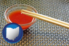 ohio map icon and chopsticks and red hot sauce in a Chinese restaurant