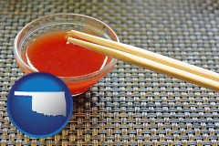 oklahoma map icon and chopsticks and red hot sauce in a Chinese restaurant