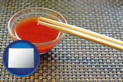 wyoming map icon and chopsticks and red hot sauce in a Chinese restaurant