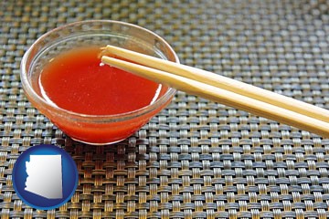 chopsticks and red hot sauce in a Chinese restaurant - with Arizona icon
