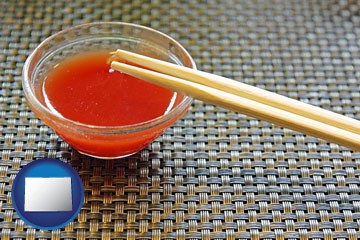 chopsticks and red hot sauce in a Chinese restaurant - with Colorado icon