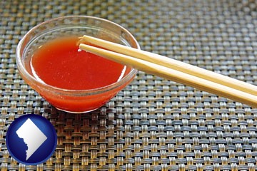 chopsticks and red hot sauce in a Chinese restaurant - with Washington, DC icon