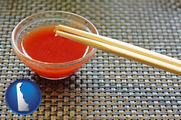 chopsticks and red hot sauce in a Chinese restaurant - with Delaware icon