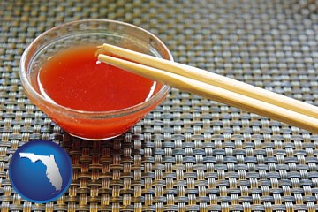 chopsticks and red hot sauce in a Chinese restaurant - with Florida icon