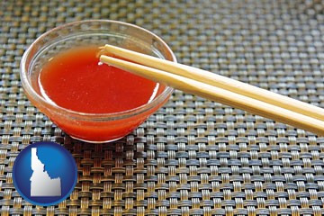 chopsticks and red hot sauce in a Chinese restaurant - with Idaho icon