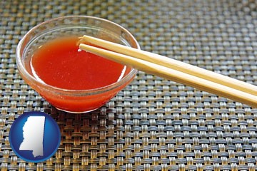 chopsticks and red hot sauce in a Chinese restaurant - with Mississippi icon