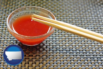 chopsticks and red hot sauce in a Chinese restaurant - with Montana icon