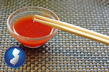 chopsticks and red hot sauce in a Chinese restaurant - with New Jersey icon