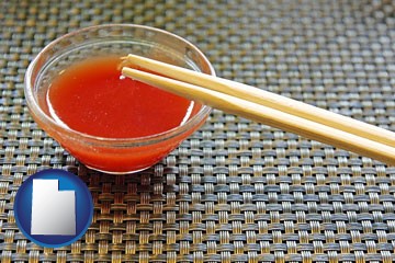 chopsticks and red hot sauce in a Chinese restaurant - with Utah icon