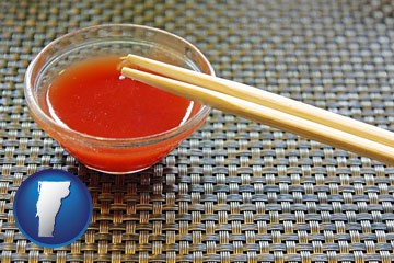chopsticks and red hot sauce in a Chinese restaurant - with Vermont icon