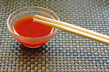 chopsticks and red hot sauce in a Chinese restaurant